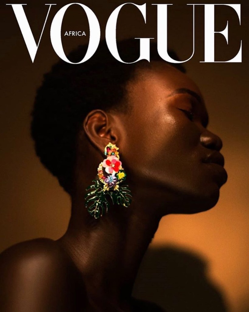 Editorial Vogue Africa cover concept: profile portrait with floral and leaf statement earring in warm directional light